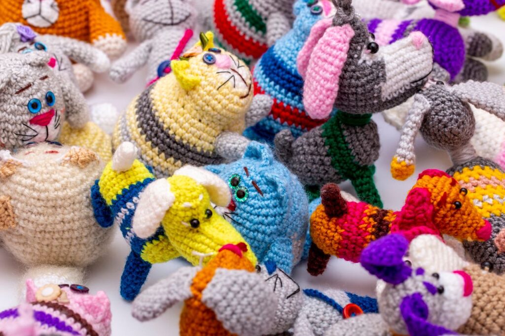 A collection of vibrant handmade crochet animals in various colors and patterns, showcasing diverse designs.